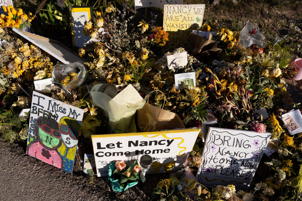 FILE - An ever-growing collection of yellow flowers and notes sit at the home of Nancy Guthrie, the missing mother of "Today" show host Savannah Guthrie, on March 6, 2026, in Tucson, Ariz. (AP Photo/Rebecca Noble, File)