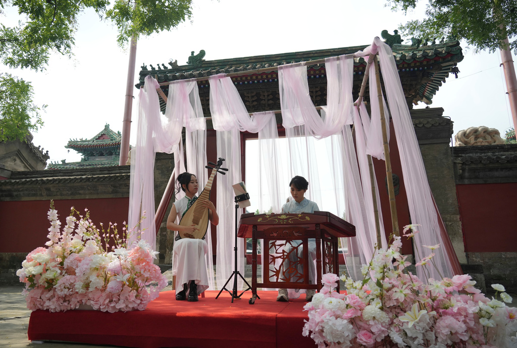 Chinese classical music performers perform at a festival to celebrate Qixi at the Beijing Folk Custom Museum in Beijing, Wednesday, Aug. 19, 2026. (AP Photo/Achmad Ibrahim)