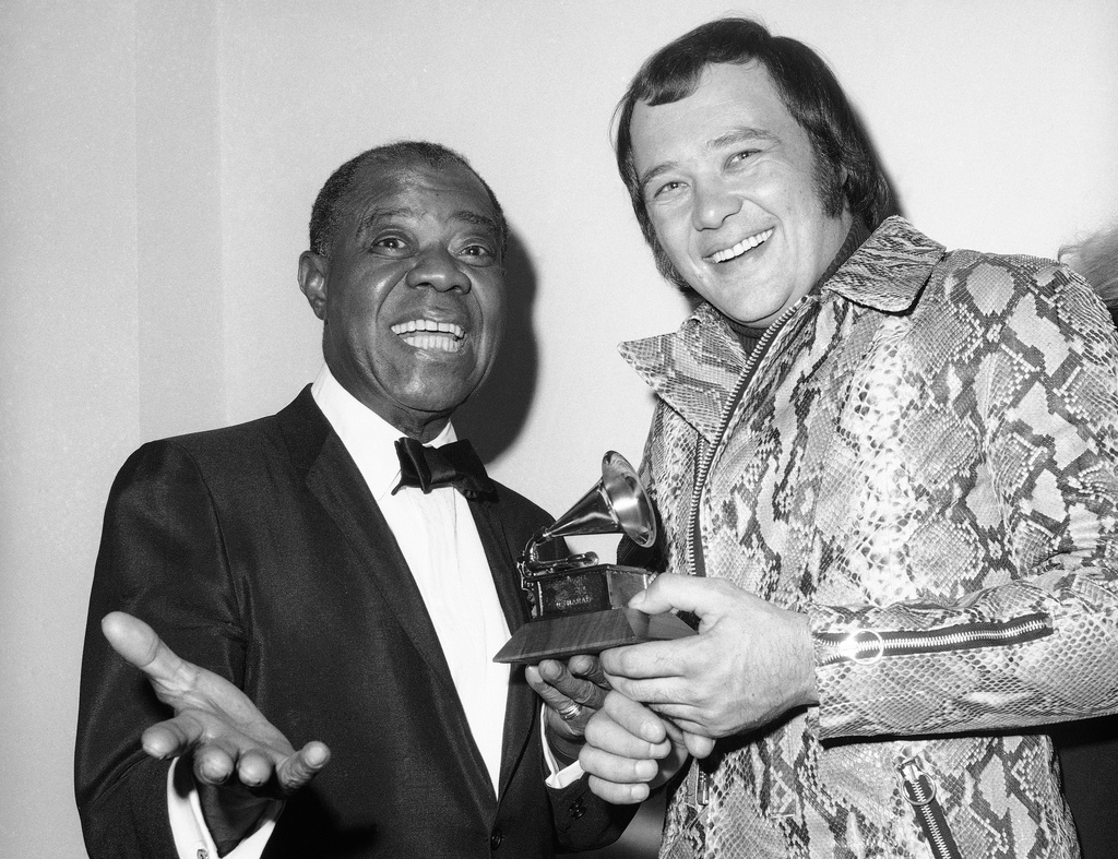 FILE - Louis Armstrong, left, presents a Grammy Award to David Clayton-Thomas, lead singer of the rock group "Blood, Sweat and Tears", in New York, March 11, 1970. (AP Photo/Dave Pickoff, File)