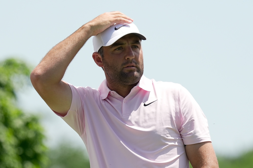 Scottie Scheffler watches his tee shot from the fifth tee during the first round of the Memorial golf tournament in Dublin, Ohio, Thursday, June 4, 2026. (AP Photo/Sue Ogrocki)