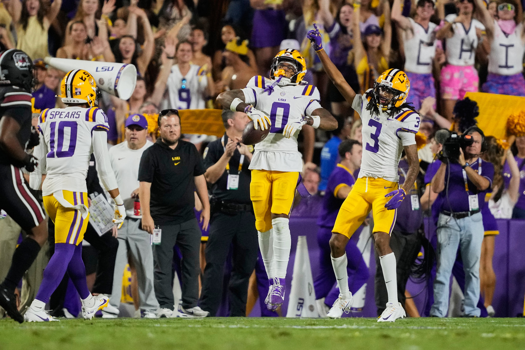 LSU safety Tamarcus Cooley (0) celebrates his inteception with cornerback DJ Pickett (3) and safety Dashawn Spears (10) in the first half of an NCAA college football game against South Carolina, Saturday, Oct. 11, 2025 in Baton Rouge, La. (AP Photo/Gerald Herbert)