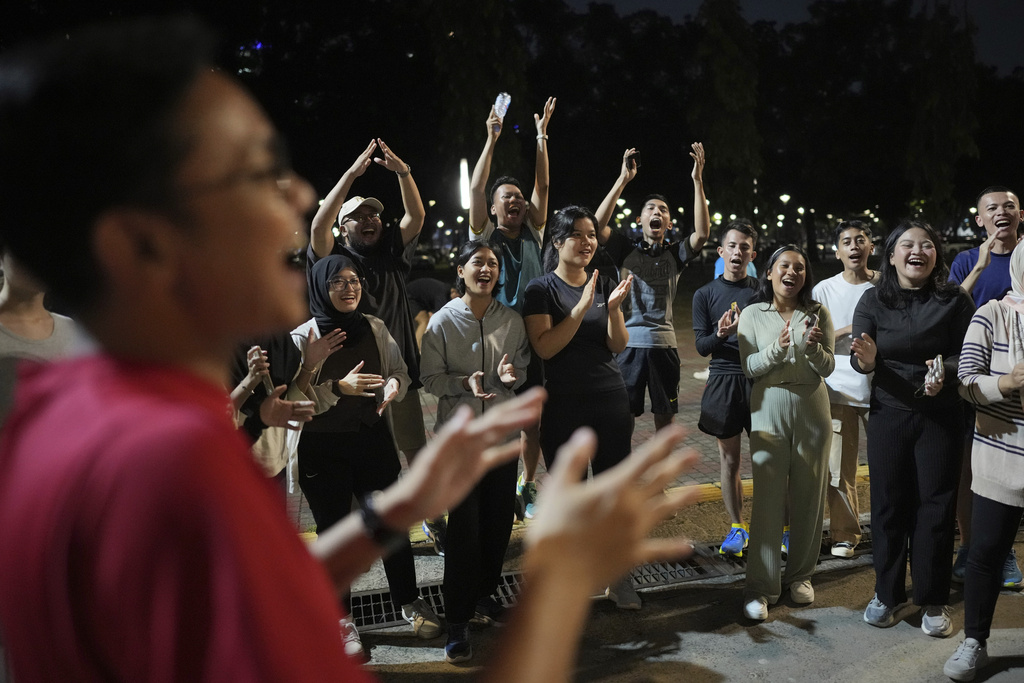 Participants cheer during a community playing gathering in Jakarta, Indonesia, Friday, July 11, 2025. (AP Photo/Dita Alangkara)