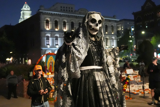 A members of Teatro del Pueblo dressed as La Catrina performs "La Danza de la Muerte" play, part of the Day of the Dead celebrations at Olvera Street, Sunday, Oct. 26, 2025, in Los Angeles. (AP Photo/Damian Dovarganes) A members of Teatro del Pueblo dressed as La Catrina performs "La Danza de la Muerte" play, part of the Day of the Dead celebrations at Olvera Street, Sunday, Oct. 26, 2025, in Los Angeles. (AP Photo/Damian Dovarganes)