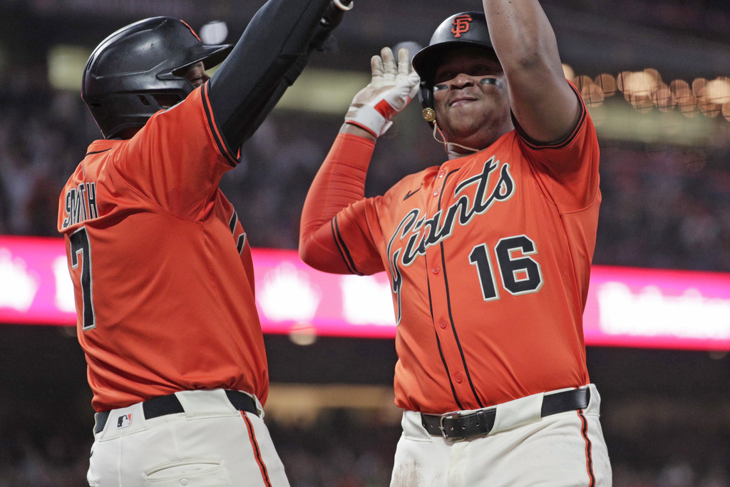 San Francisco Giants designated hitter Rafael Devers (16) scores on an RBI double by the Giants' Willy Adames (2) in the first inning of a baseball game Friday, Sept. 12, 2025, in San Francisco. (Santiago Mejia/San Francisco Chronicle via AP)