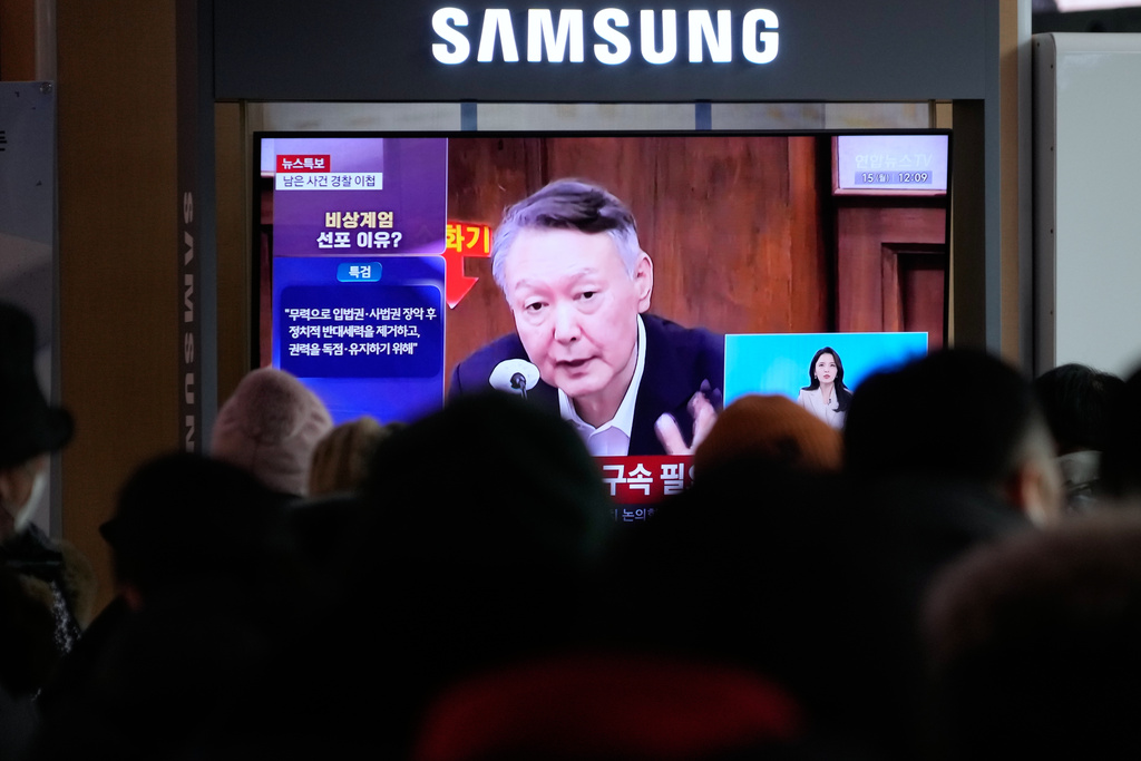 A TV screen shows a file image of South Korea's ousted President Yoon Suk Yeol during a news program at the Seoul Railway Station in Seoul, South Korea, Monday, Dec. 15, 2025. (AP Photo/Ahn Young-joon)
