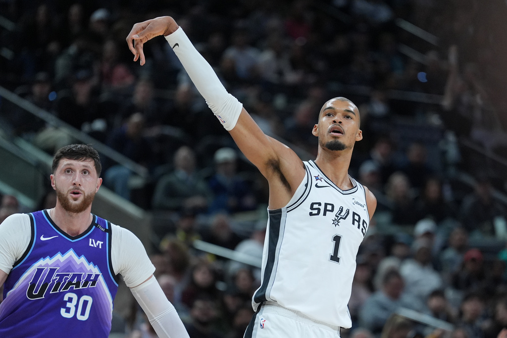 San Antonio Spurs forward Victor Wembanyama (1) watches his shot was Utah Jazz center Jusuf Nurkic (30) looks on during the first half of an NBA basketball game in San Antonio, Monday, Jan. 19, 2026. (AP Photo/Eric Gay)