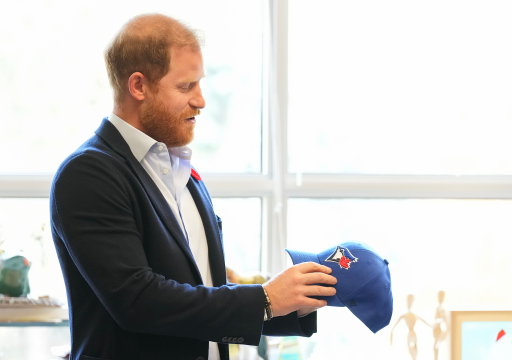Prince Harry received a Toronto Blue Jays hat as he meets with some of Canada's oldest veterans, joining them in a creative arts program at Sunnybrook Hospital's veterans center in Toronto, Thursday, Nov. 6, 2025. (Nathan Denette /The Canadian Press via AP)