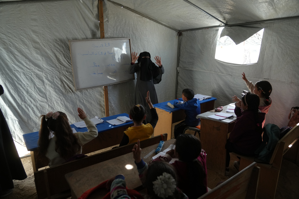 Palestinian children attend class in a tent classroom at an orphanage camp in Khan Younis, southern Gaza Strip, Thursday, Feb. 12, 2026. (AP Photo/Jehad Alshrafi)