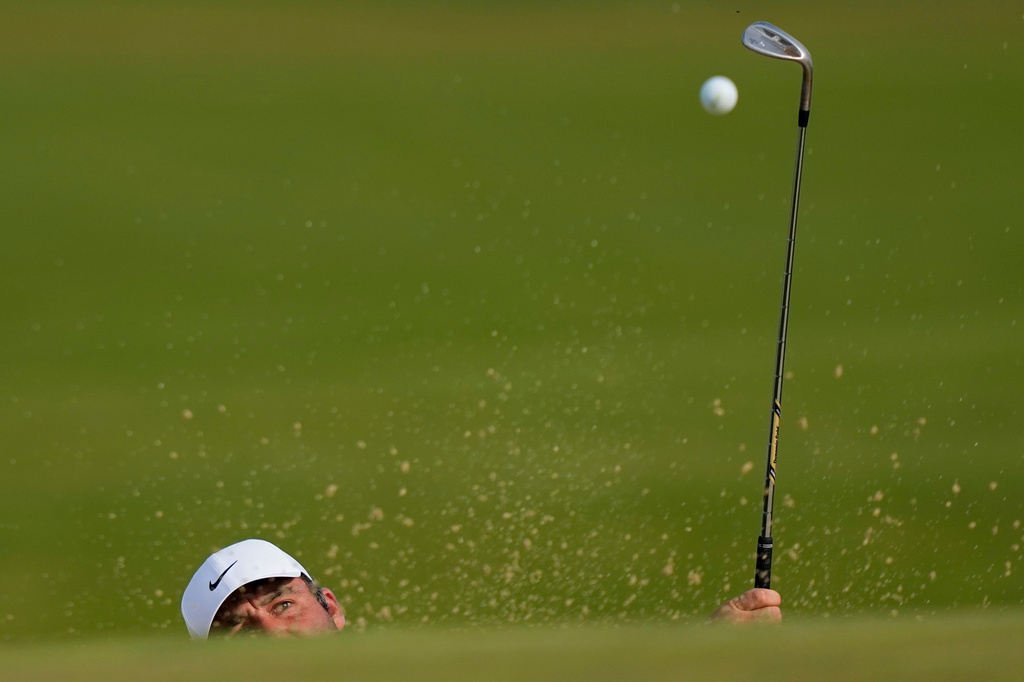 Scottie Scheffler hits out of the bunker on the 16th green during the third round of the PGA Championship golf tournament at Aronimink Golf Club, Saturday, May 16, 2026, in Newtown Square, PA. (AP Photo/Matt Slocum)