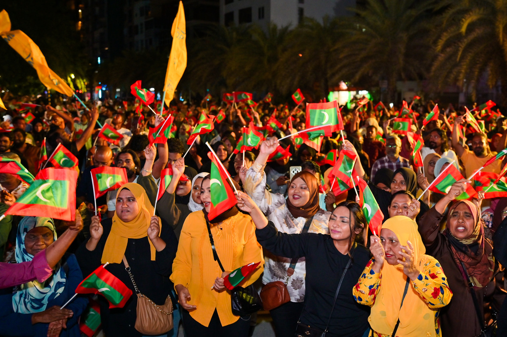 Opposition supporters wave Maldivian national flags during an anti-government protest in Male, Maldives, Friday, Oct, 3, 2025. (AP Photo/ Mohamed Sharhaan)