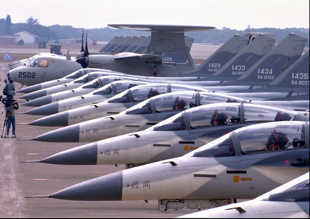 FILE - Some of the 18 Taiwanese-built Indigenous Defensive Fighters and one U.S.-made E-2T airborne warning plane are displayed at Chingchuankang military base in Taichung, central Taiwan Wednesday November 22, 1995 for their commissioning ceremony. (75 miles) southwest of Taipei. (AP Photo/Eddie Shih, File)