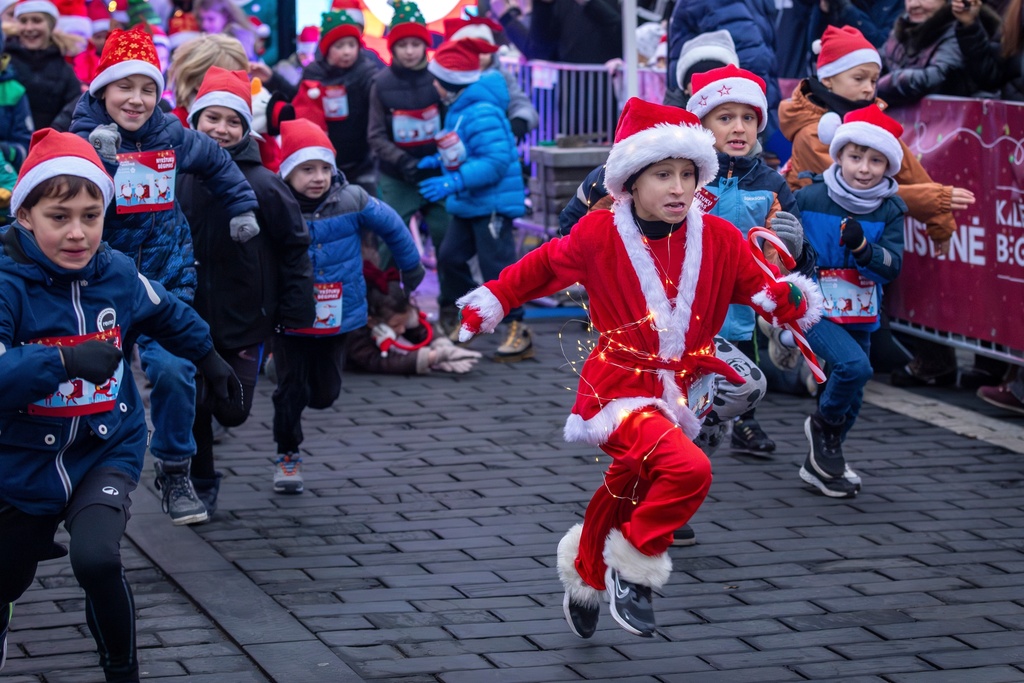 FILE - Decked in a Santa outfit and holiday lights, a child bolts from the starting line of the annual Christmas run in Vilnius, Lithuania, Saturday, Dec. 6, 2025. (AP Photo/Mindaugas Kulbis, File)