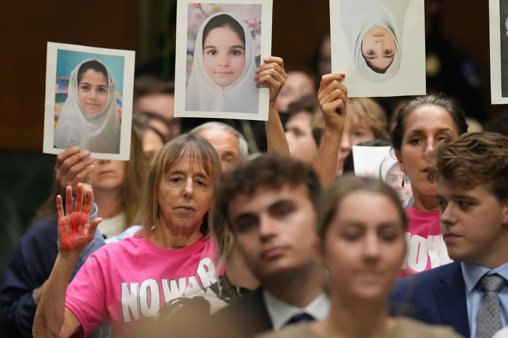 Code Pink co-founder Medea Benjamin, left, listens as Defense Secretary Pete Hegseth testifies at a Senate Appropriations Committee hearing, Tuesday, July 21, 2026, on Capitol Hill in Washington. (AP Photo/Jacquelyn Martin)