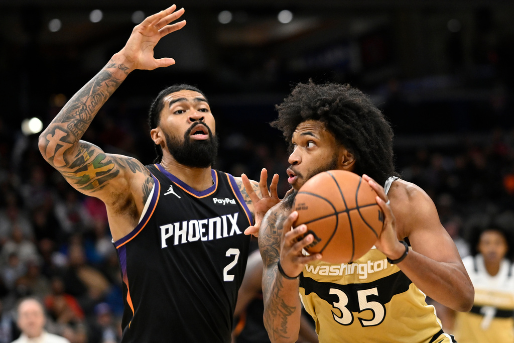 Washington Wizards forward Marvin Bagley III (35) works against Phoenix Suns center Nick Richards (2) for a shot attempt during the first half of an NBA basketball game, Monday, Dec. 29, 2025, in Washington. (AP Photo/John McDonnell)
