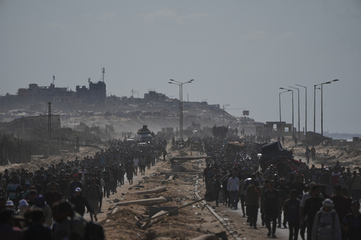 Displaced Palestinians walk with their belongings along the coastal road near Wadi Gaza in the central Gaza Strip, moving toward Gaza City, Friday, Oct. 10, 2025, after Israel and Hamas have agreed to a pause in their war and the release of the remaining hostages. (AP Photo/Abdel Kareem Hana) Displaced Palestinians walk with their belongings along the coastal road near Wadi Gaza in the central Gaza Strip, moving toward Gaza City, Friday, Oct. 10, 2025, after Israel and Hamas have agreed to a pause in their war and the release of the remaining hostages. (AP Photo/Abdel Kareem Hana)