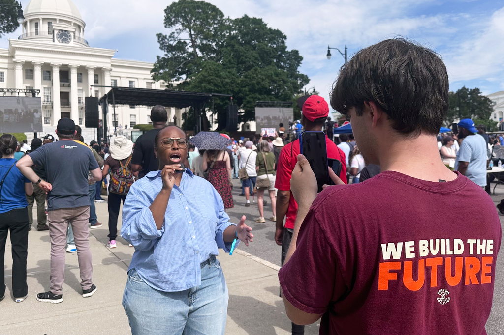 Kobe Chernushin, right, records Khayla Doby for the Georgia Youth Justice Coalition during a voting rights rally in Montgomery, Ala., Saturday, May 16, 2026. (AP Photo/Bill Barrow)