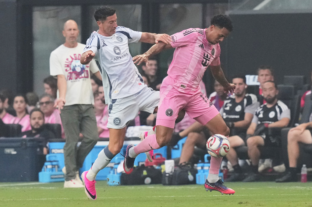 Chicago Fire forward Robert Lewandowski, left, competes for the ball against Inter Miami defender Ian Fray, right, during the first half of an MLS soccer match, Wednesday, July 22, 2026, in Miami. (AP Photo/Lynne Sladky)