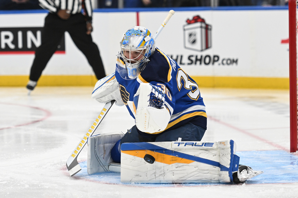 St. Louis Blues goaltender Joel Hofer (30) blocks a shot from the Winnipeg Jets during the first period of an NHL hockey game on Wednesday, Dec. 17, 2025, in St. Louis. (AP Photo/Joe Puetz)