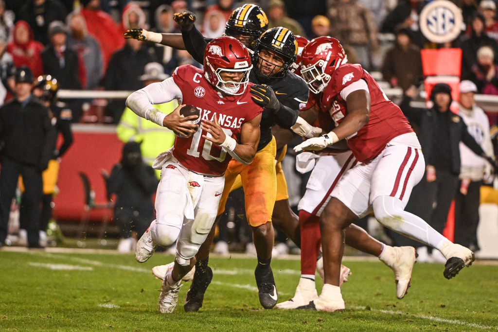 Arkansas quarterback Taylen Green (10) is sacked by Missouri defensive end Damon Wilson II, center, during the second half of an NCAA college football game Saturday, Nov. 29, 2025, in Fayetteville, Ark. (AP Photo/Michael Woods)
