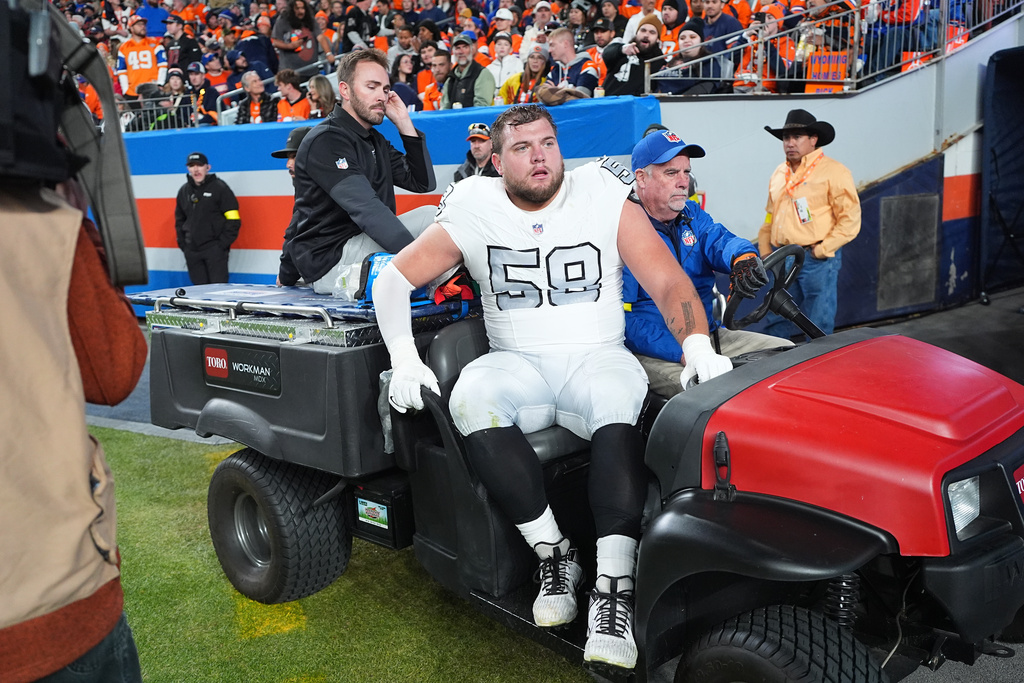 FILE - Las Vegas Raiders guard Jackson Powers-Johnson (58) is carted off the field after being injured while playing against the Denver Broncos in the first half of an NFL football game, Thursday, Nov. 6, 2025, in Denver. (AP Photo/David Zalubowski, File)