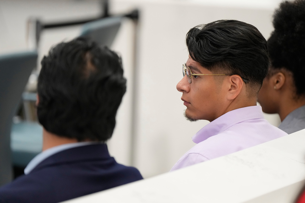 Lorenzo Salgado Araujo, Jr., right, and Ronaldo Salgado, left, listen during an oversight forum on Friday, July 24, 2026, in Houston, about the death of their father, Lorenzo Salgado Araujo, who was shot and killed by an ICE officer. (AP Photo/Ashley Landis)