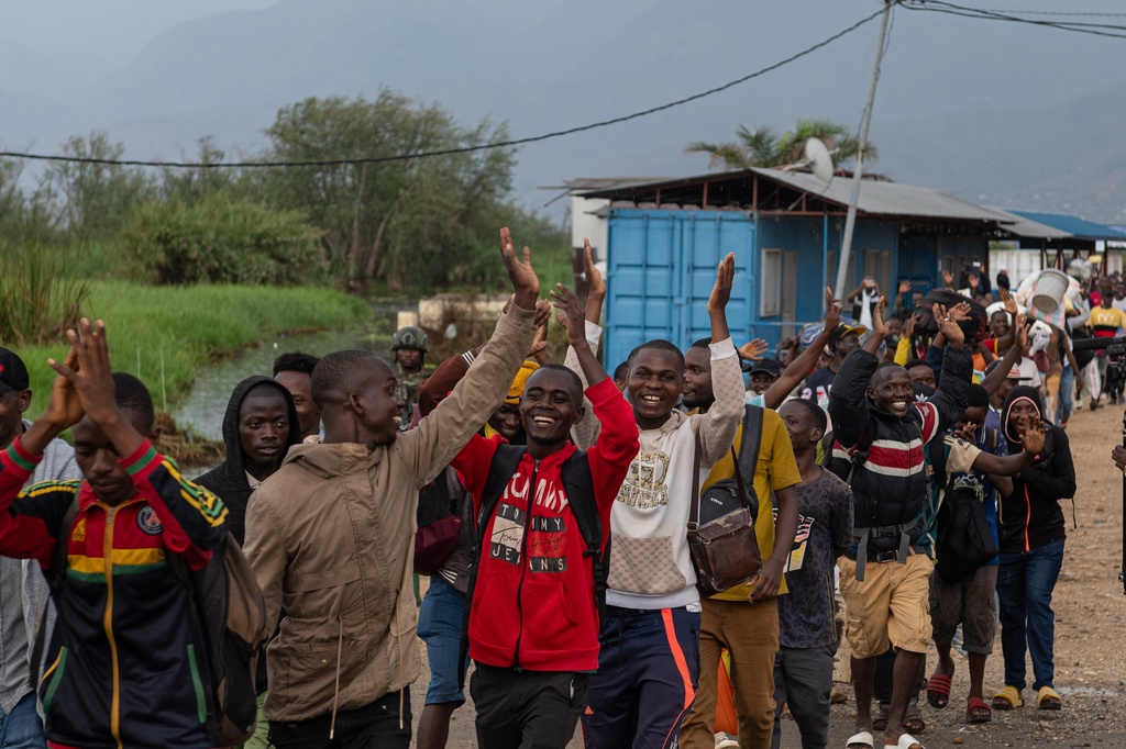 Burundian citizens who work in Uvira, Democratic Republic of the Congo, and could not cross back into their home country due to fighting, cross the border into Burundi, Sunday, Dec. 14, 2025. (AP Photo/Moses Sawasawa)