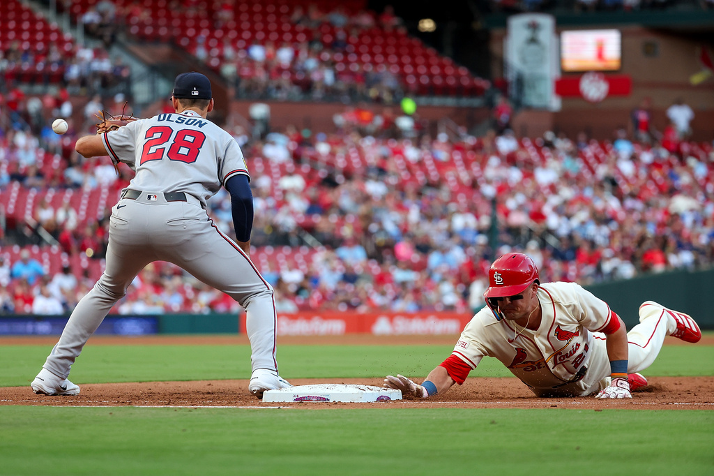 St. Louis Cardinals' Lars Nootbaar dives back to first base to avoid the pick off throw to Atlanta Braves' Matt Olson during the fourth inning of a baseball game, Saturday, July 11, 2026, in St. Louis. (AP Photo/Scott Kane)