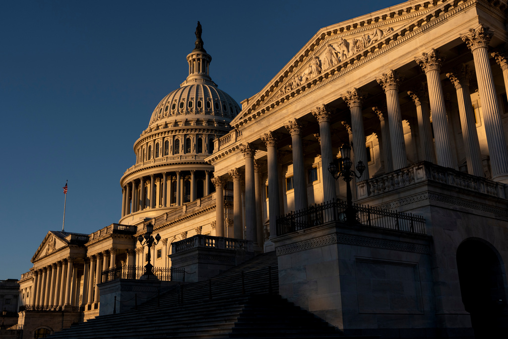 The Senate side of the Capitol is illuminated by the sun at dawn in Washington, Monday, Oct. 6, 2025. (AP Photo/J. Scott Applewhite)