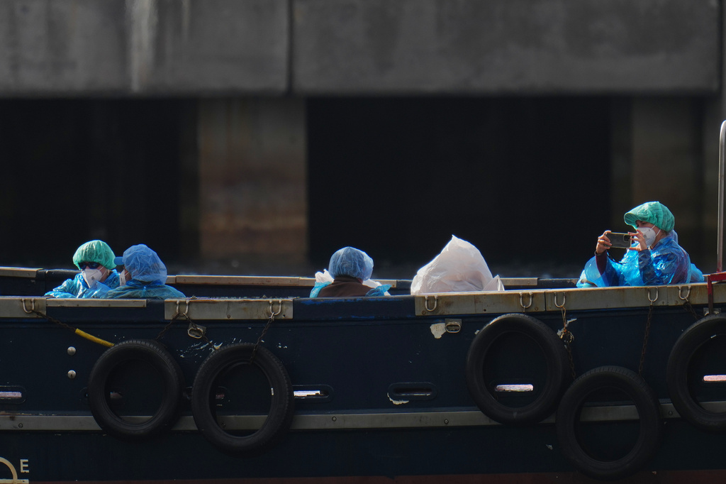 Passengers are disembarked from the hantavirus-stricken cruise ship MV Hondius at the port of Granadilla in Tenerife, Canary Islands, Spain, Sunday, May 10, 2026. (AP Photo/Manu Fernandez)