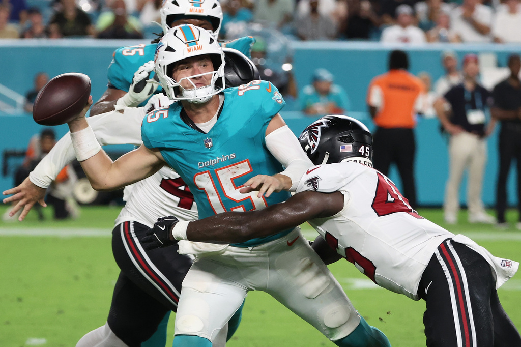 Miami Dolphins quarterback Cam Miller (15) is pressured by Atlanta Falcons linebacker Christian Harris (45) during the first half of an NFL preseason football game, Friday, Aug. 28, 2026, in Miami Gardens, Fla. (AP Photo/David Santiago)