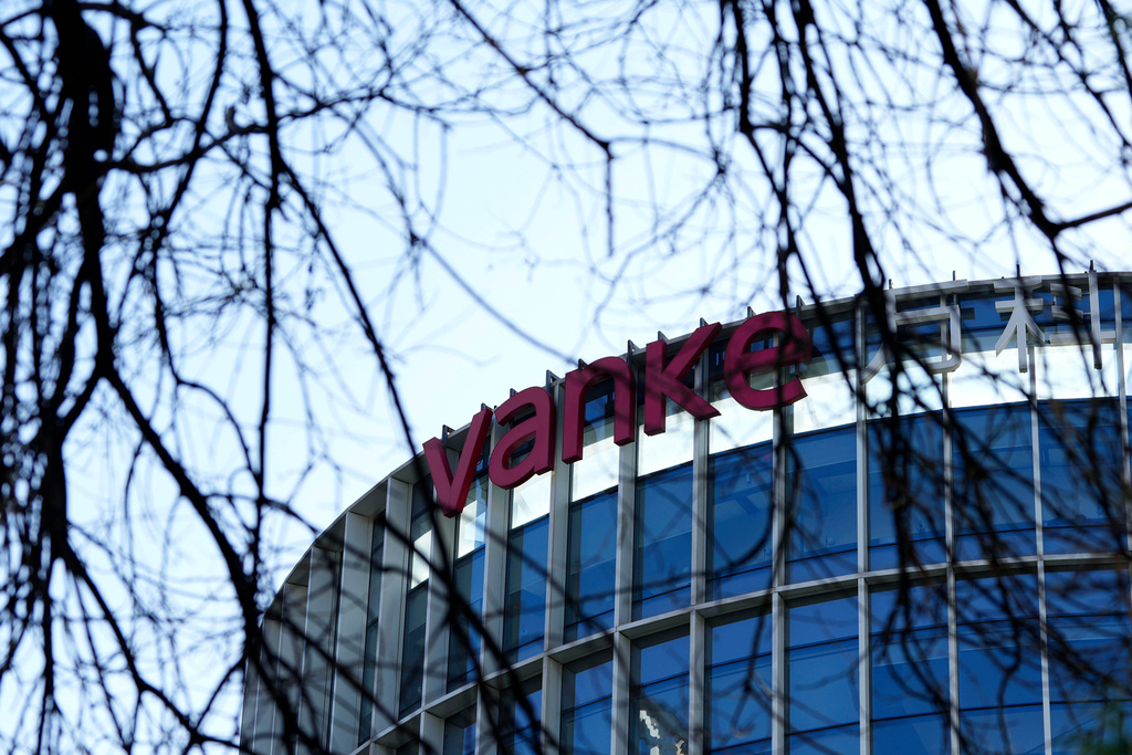 The Vanke logo is seen on a commercial complex in Beijing, China, Wednesday, Dec. 24, 2025. (AP Photo/Ng Han Guan)