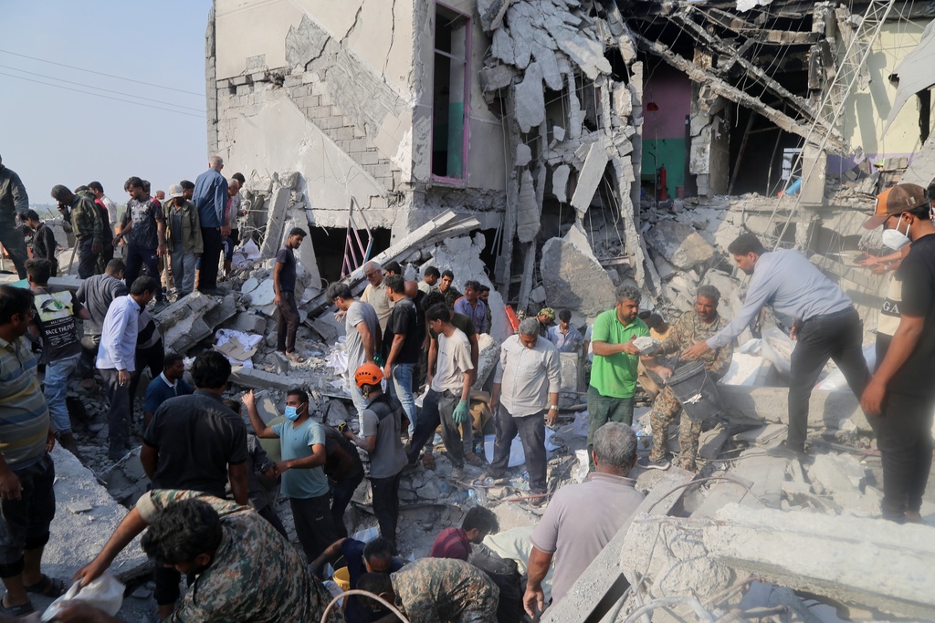 Rescue workers and residents search through the rubble in the aftermath of a strike on a girls' elementary school in Minab, Iran, Saturday, Feb. 28, 2026. (Abbas Zakeri/Mehr News Agency via AP)