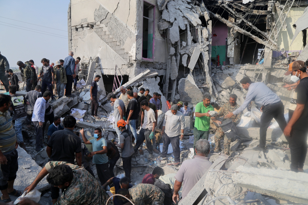 Rescue workers and residents search through the rubble in the aftermath of a strike on a girls' elementary school in Minab, Iran, Saturday, Feb. 28, 2026. (Abbas Zakeri/Mehr News Agency via AP)