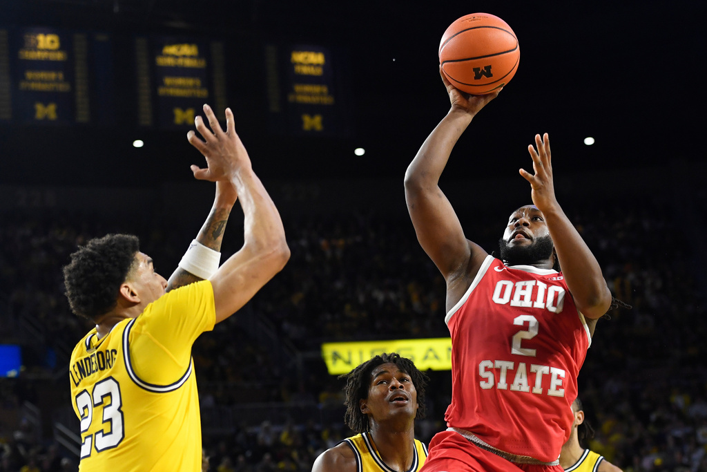 Ohio State guard Bruce Thornton (2) shoots the ball past Michigan forward Yaxel Lendeborg, left, and forward Morez Johnson Jr. (21) during the first half of an NCAA college basketball game, Friday, Jan. 23, 2026, in Ann Arbor, Mich. (AP Photo/Jose Juarez)