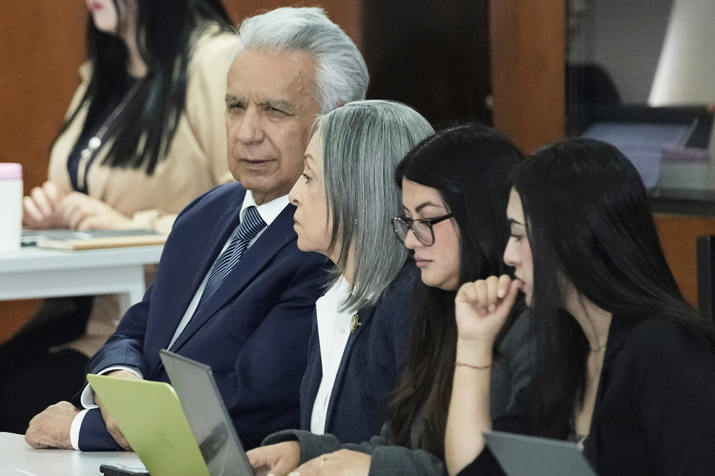 Ecuador's former President Lenin Moreno, who is charged with accepting bribes from Chinese company Sinohydro in connection with the construction of one of the country's hydroelectric power plants, attends a hearing accompanied by his wife, Rocio Gonzalez, center, at the National Court of Justice in Quito, Ecuador, Friday, Aug. 28, 2026. (AP Photo/Dolores Ochoa)