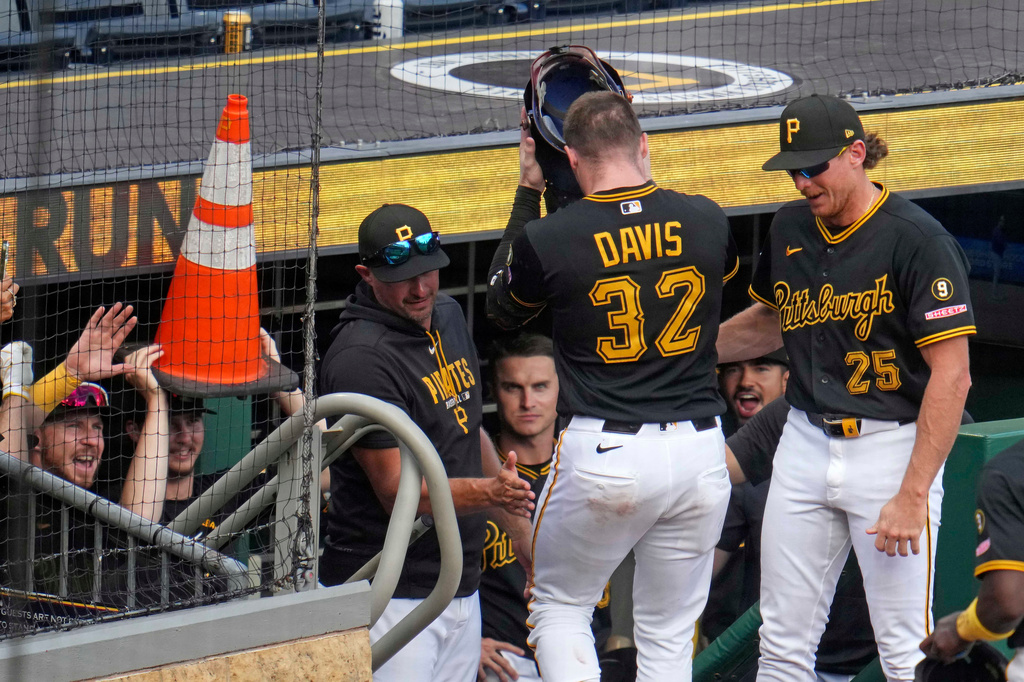 Pittsburgh Pirates' Henry Davis (32) dons the team's ceremonial welder's helmet as he returns to the dugout after hitting a two-run home run off Milwaukee Brewers pitcher Aaron Ashby during the eighth inning of a baseball game in Pittsburgh, Thursday, Sept. 17, 2026. (AP Photo/Gene J. Puskar)