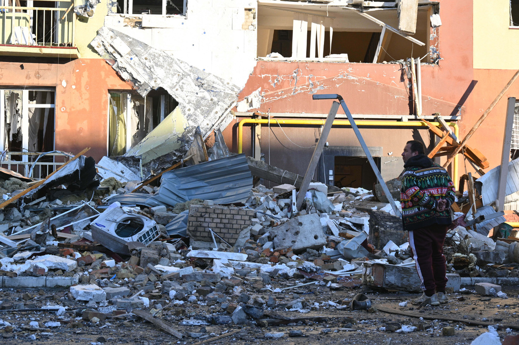 A local man stands in front of residential building which was heavily damaged after a Russian strike in Odesa, Ukraine, Monday, April 6, 2026. (AP Photo/Michael Shtekel)