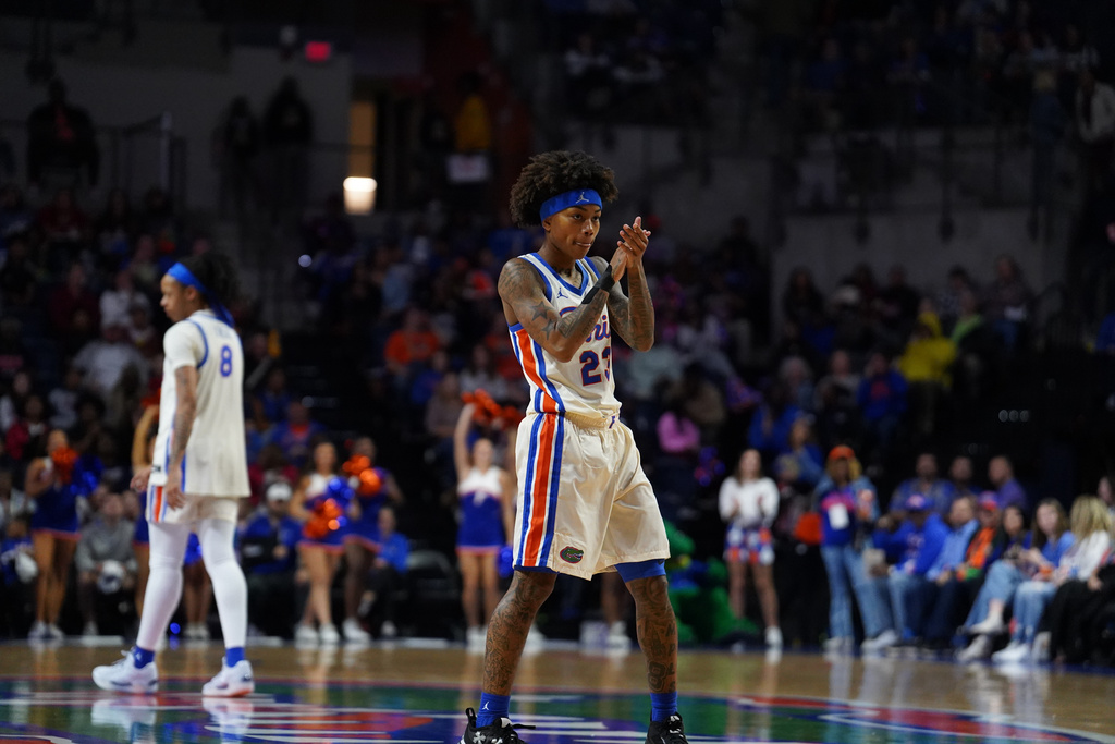 Florida guard Liv McGill, center, celebrates during the first half of an NCAA college basketball game against South Carolina, Sunday, Jan. 4, 2026, in Gainesville, Fla. (AP Photo/Morgan Hurd)