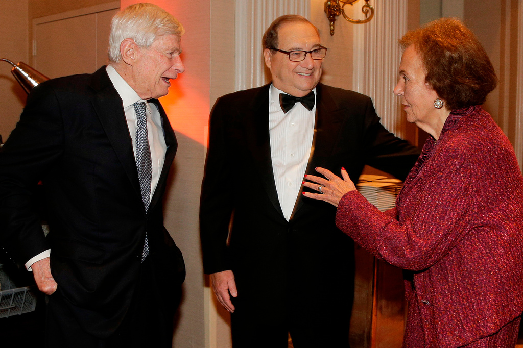 FILE - In this June 17, 2015 photo, Anti-Defamation League National Director Abe Foxman, center, greets ADL education committee co-chair Charlotte Frank, right, and Fred Malek during a reception for a dinner in Foxman's honor in New York. (AP Photo/Julie Jacobson, File)