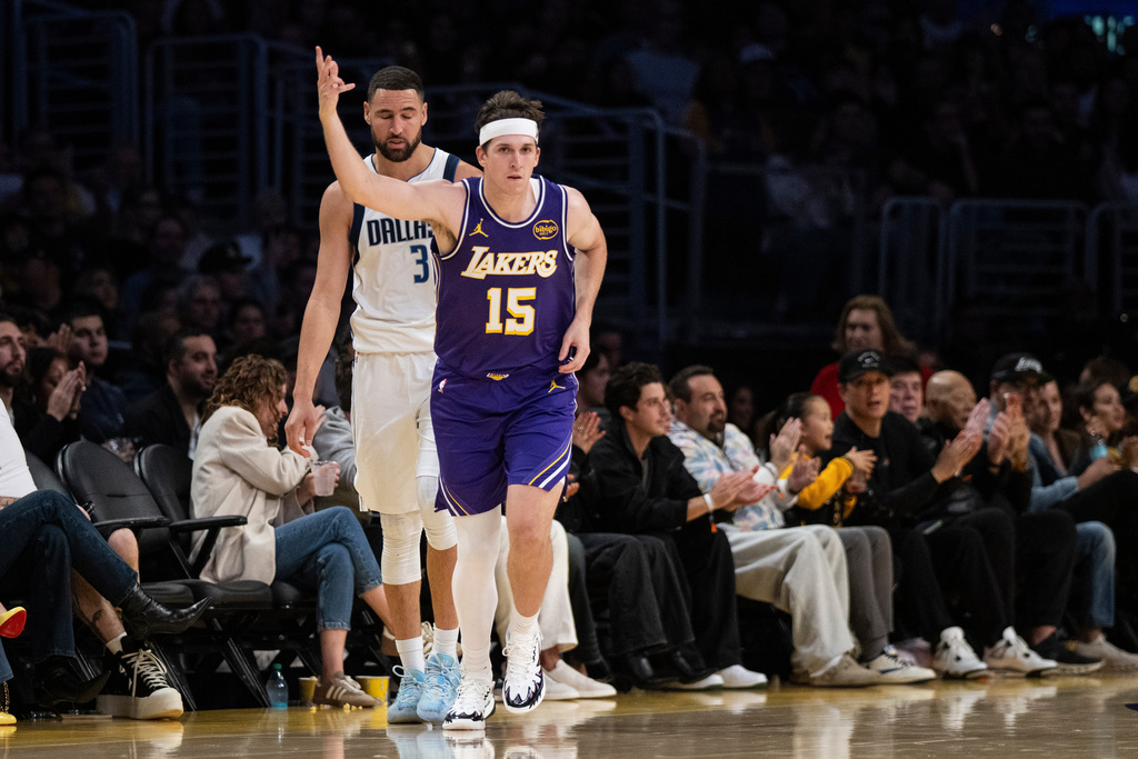 Los Angeles Lakers guard Austin Reaves (15) gestures after scoring a 3-point basket during the first half of an NBA Cup basketball game against the Dallas Mavericks in Los Angeles, Friday, Nov. 28, 2025. (AP Photo/Kyusung Gong)