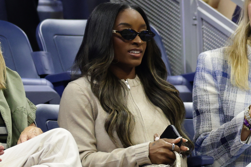 Olympic gymnast Simone Biles watches Jessica Pegula, of the United States, play Emma Navarro, of the United States, in the quarterfinal round of the U.S. Open tennis championships, Tuesday, Sept. 8, 2026, in New York. (AP Photo/Adam Hunger)