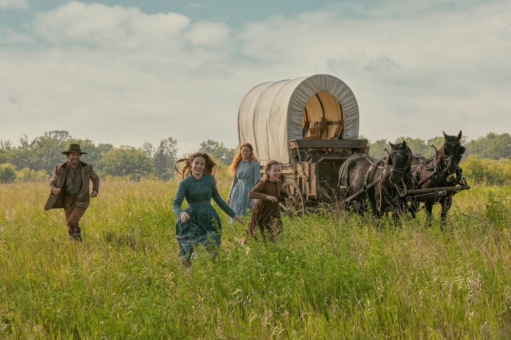 This image released by Netflix shows, from left, Luke Bracey as Charles Ingalls, Skywalker Hughes as Mary Ingalls, Crosby Fitzgerald as Caroline Ingalls, and Alice Halsey as Laura Ingalls, in a scene from "Little House on the Prairie." (Eric Zachanowich/Netflix via AP)