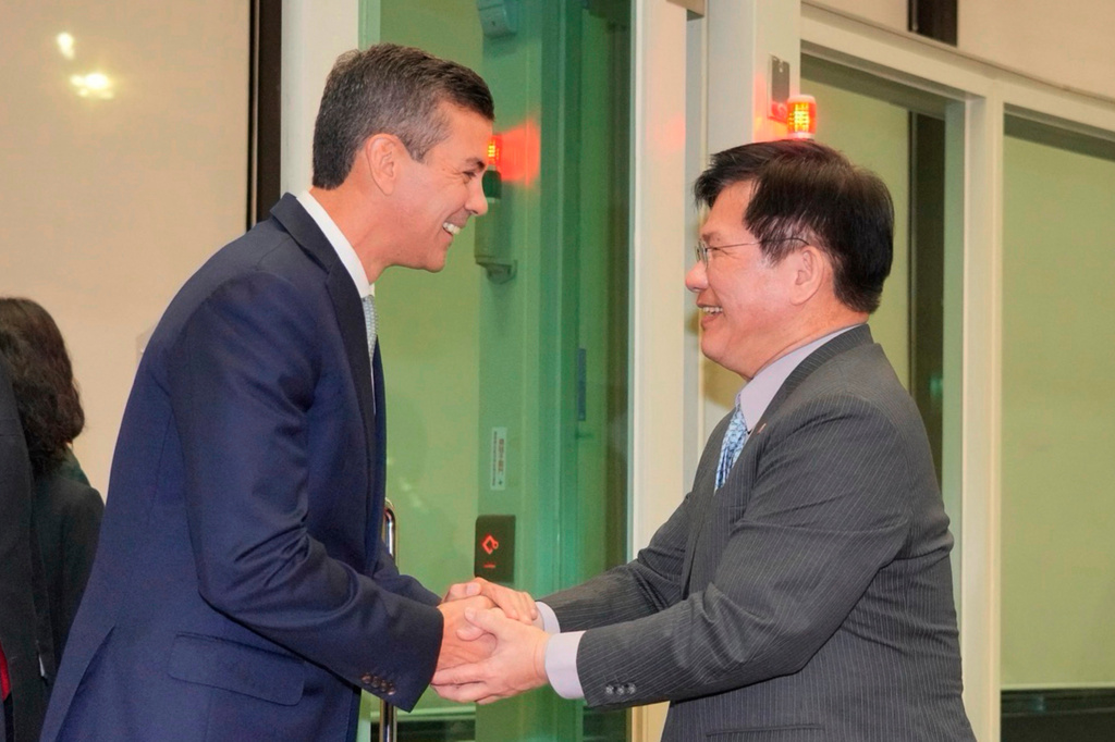 In this image taken from video released by the Taiwan Ministry of Foreign Affairs, Paraguayan President Santiago Peña, left, is greeted by Taiwan's Foreign Minister Lin Chia-lung upon arrival in Taipei, Taiwan on Thursday, May 7, 2026. (Taiwan Ministry of Foreign Affairs via AP)