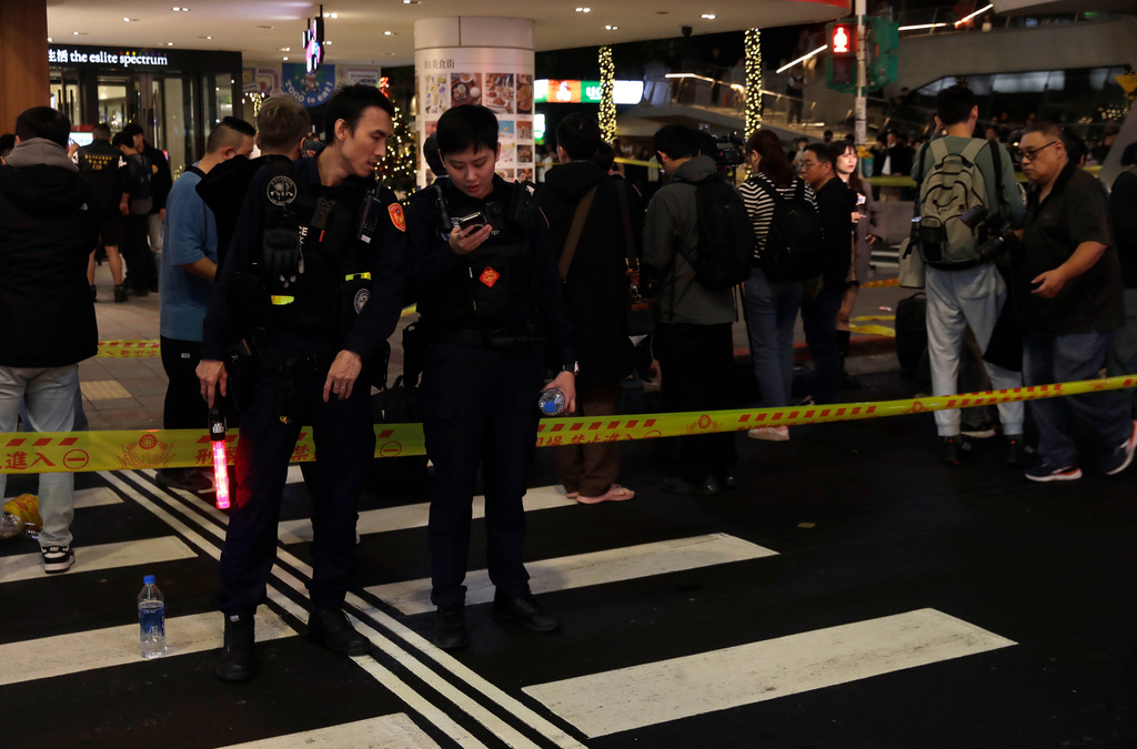 Taiwan police cordoned off the scene after a knife attack in Taipei, Taiwan, Friday, Dec. 19, 2025. (AP Photo/Chiang Ying-ying)