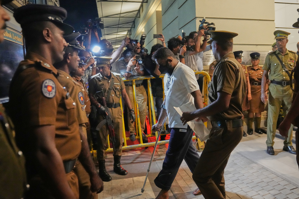 An unidentified man convicted for his involvement in the 2019 Easter bombings are escorted to a prison in Colombo, Wednesday, Sept. 23, 2026. (AP Photo/Eranga Jayawardena)