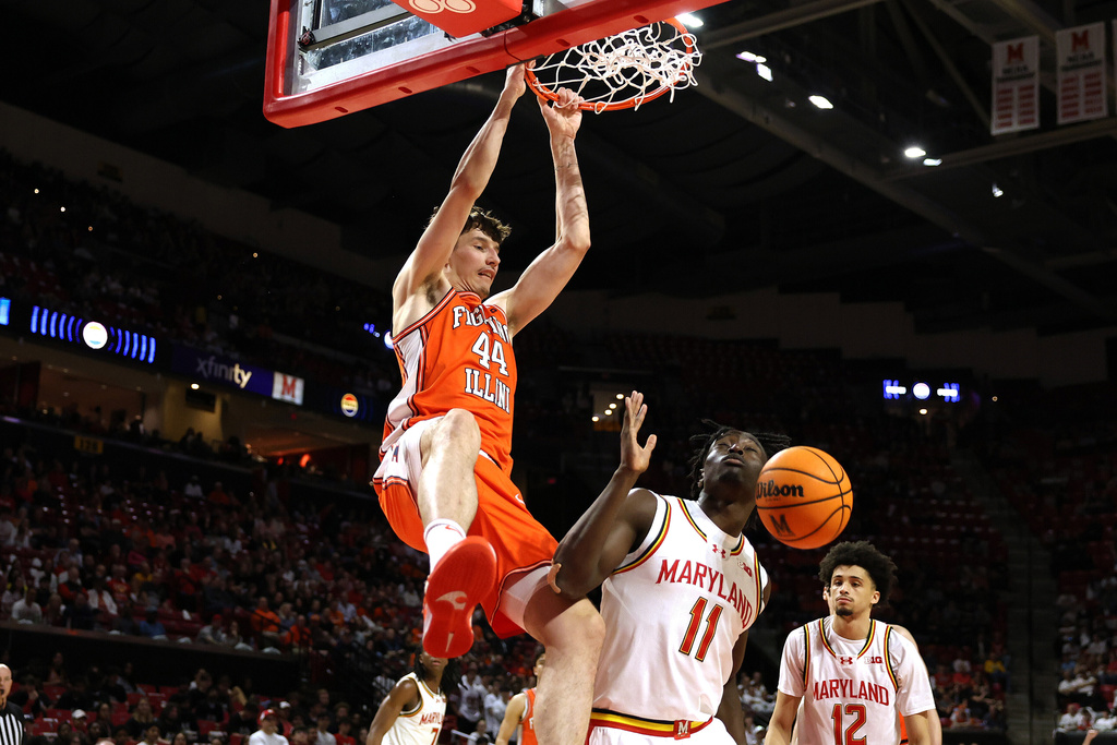Illinois center Zvonimir Ivisic (44) dunks over Maryland guard George Turkson Jr. (11) during the first half of an NCAA college basketball game, Sunday, March 8, 2026, in College Park, Md. (AP Photo/Daniel Kucin Jr.)