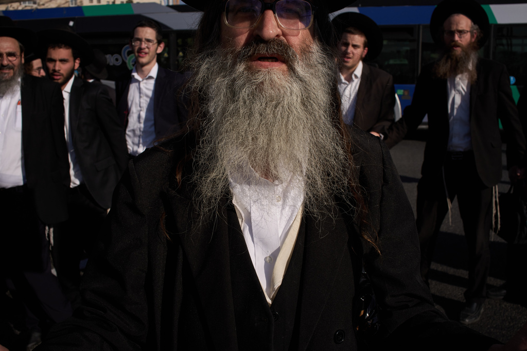 Ultra-Orthodox Jewish men block a road during a protest against army recruitment in Jerusalem, Wednesday, April 29, 2026. (AP Photo/Leo Correa)