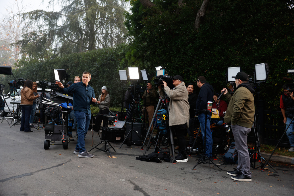 News crews stage outside Rob Reiner's residence Monday, Dec. 15, 2025, in the Brentwood section of Los Angeles. (AP Photo/Caroline Brehman)