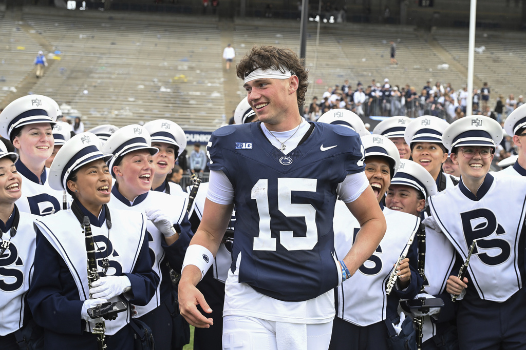 Penn State quarterback Drew Allar celebrates with Blue Band members after defeating Florida International in an NCAA college football game, Saturday, Sept. 6, 2025, in State College, Pa. (AP Photo/Barry Reeger)