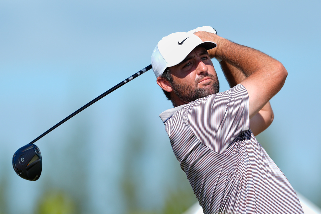 FILE - Scottie Scheffler, of the United States, watches his tee-off at the fourth hole during the final round of the Hero World Challenge PGA Tour at the Albany Golf Club in New Providence, Bahamas, Dec. 7, 2025. (AP Photo/Fernando Llano, File)